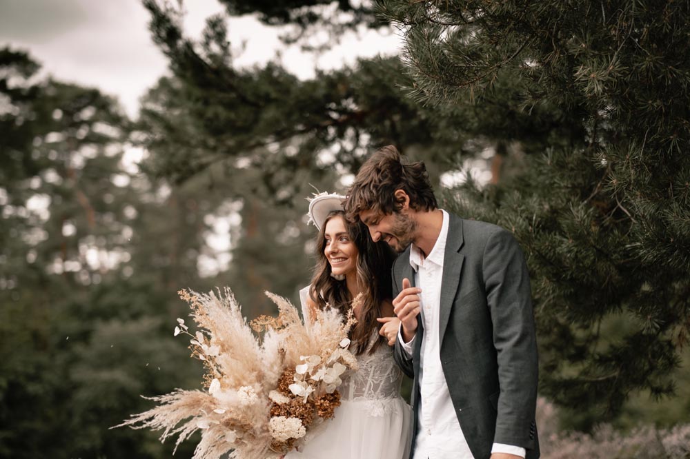 Boho bride and groom in wedding dress outdoors in Bonn by wedding photographer