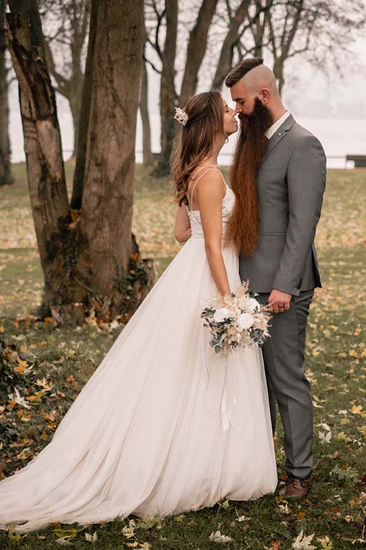 boho bride and groom in wedding dress by the lake constance by wedding photographer